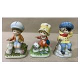 Three 4-2/3' tall figurines. One on the left is a Three 4-2/3' tall figurines. One on the left is a