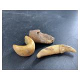 Three ancient Alaskan finds: a small canine tooth,