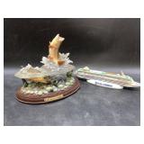 Rainbow trout statuette and a small bottle of Maje