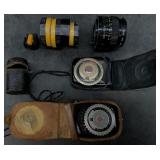 Vintage camera parts and lenses in a cigar box