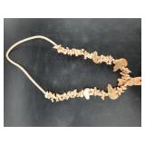 Stone statement necklace with dozens of carved ani
