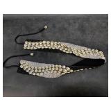 A hand beaded seashell sash in a cherry wood box
