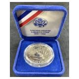 1986 S Ellis Island silver dollar in mint case