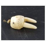 Old walrus ivory talisman depicting a walrus head