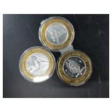 3 $10 silver and brass gaming tokens with each hav
