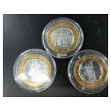 3 $10 silver and brass gaming tokens with each hav