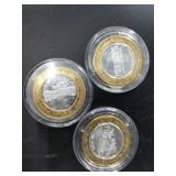 3 $10 silver and brass gaming tokens with each hav