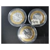 3 $10 silver and brass gaming tokens with each hav