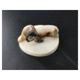 Fossilized ivory walrus carving on an ivory base,