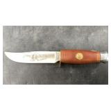 Short camping knife with stacked leather handle an