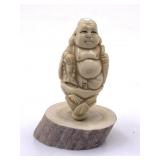 Carved netsuke of Buddha mounted on an antler base