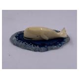 Carved ivory whale on polished agate base about 2"