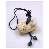 Turtle and pig netsuke on a string to use as keych