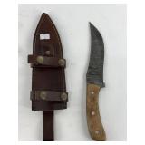 Damascus bladed knife with wood scales and four wa