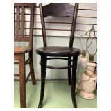 Antique wood chair by Mundus with carved back