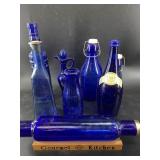 Cobalt blue glassware including vintage bottles