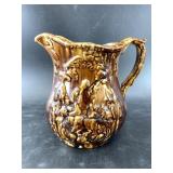 Antique German stoneware pitcher depicting traditi