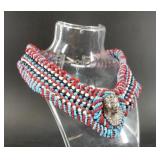 Hand beaded collar necklace with a silver-toned ph