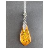 Amber pendant on a silver tone hook