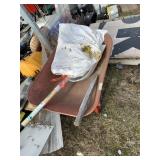 Lot with a wheelbarrow with a broken handle and a
