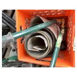 Crate full of aluminum sheeting and pruning shears