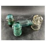 3 Glass insulators and a rolling pin fishing float