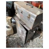 Lot with a metal tool box, heavily damaged,  and a