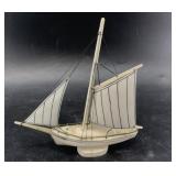 Arnie Iyakitan ivory single masted sail boat with