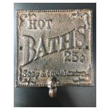 Cast iron wall hook that says 'Hot BATHS 25ï¿½'. It