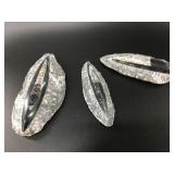 Three orthoceras fossils partially carved out, in