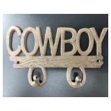 Brand new cast iron double wall hook that says 'CO