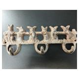 Brand new cast iron triple wall hook, depicting se