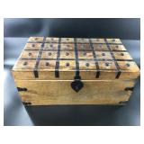 Wooden chest with metal detailing on top and corne