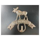 Cast iron wall hook that says 'Welcome' with a moo