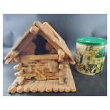 Scale log cabin and a vintage tin