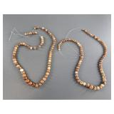 Two strands of fossilized ivory beads