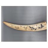 Fossilized walrus ivory tusk with scrimshaw of flo