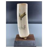 Scrimshaw of a duck taking off on a piece of fossi