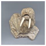 Soapstone carving of walrus with walrus ivory tusk