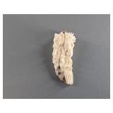 Mammoth ivory pendant carved with variety of Alask