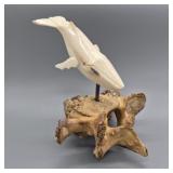 Fossilized walrus ivory carving of a whale, signed