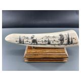 Scrimshawed walrus tusk depicting bear and caribou