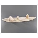 3 Bone carvings of Native Alaskans and igloos on a