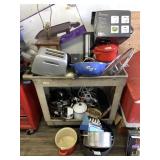 plastic cart with cooking pans, toaster, table lam
