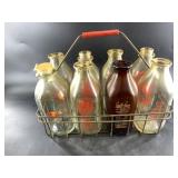 8 Dairy bottles and steel carrier