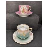 PR OF MUSTACHE CUPS AND SAUCERS