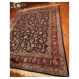 Persian inspired wool rug.  Navy ground floral