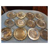 11 Pewter golf award plates and 1 silver plate.