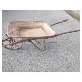 Antique metal wheel wheel barrel.    Look at the