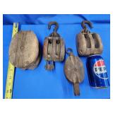 4 vintage block and tackle.  1 has wood wheel.